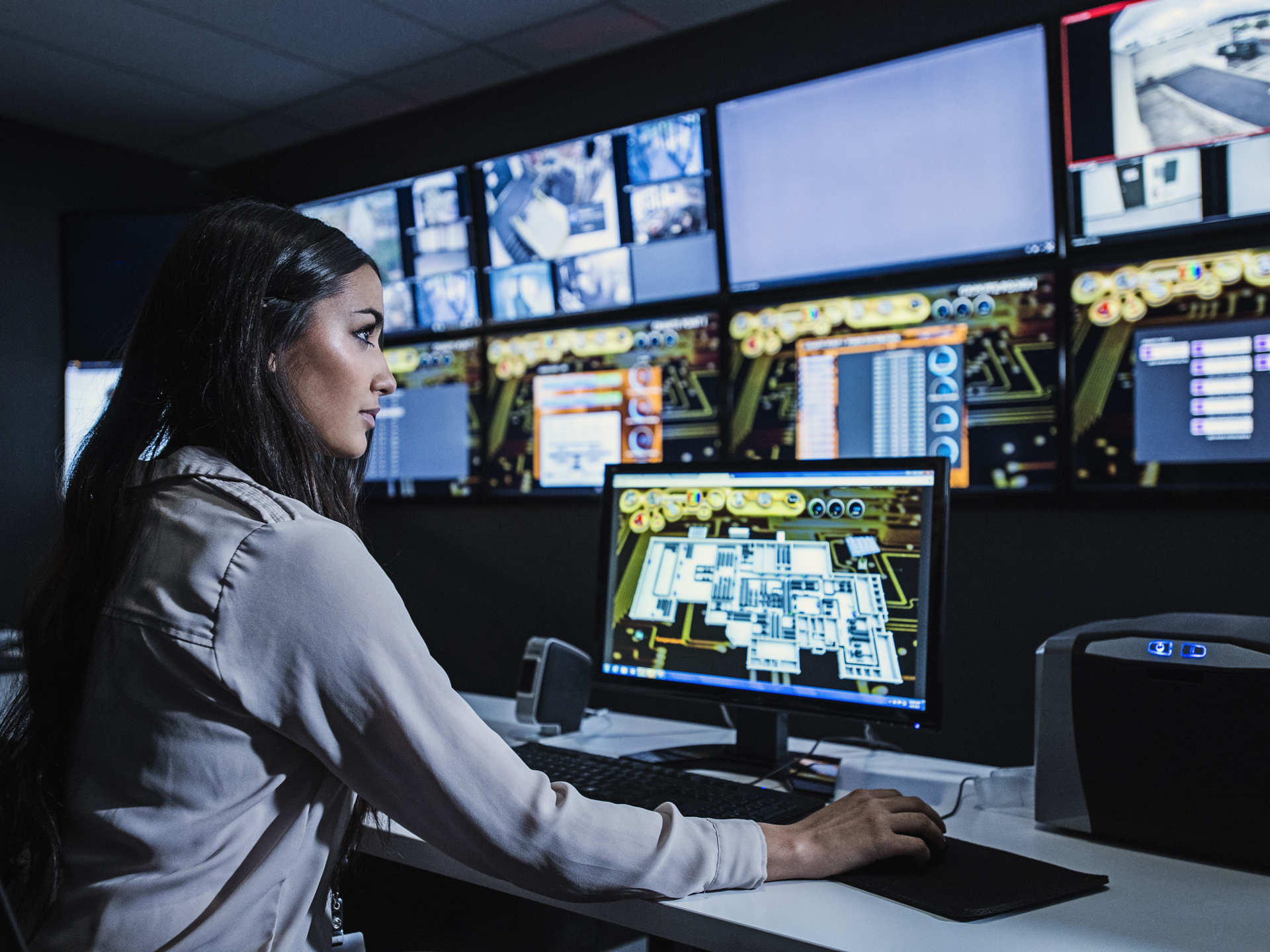 Airport command center worker monitoring passenger flow and queues in airport