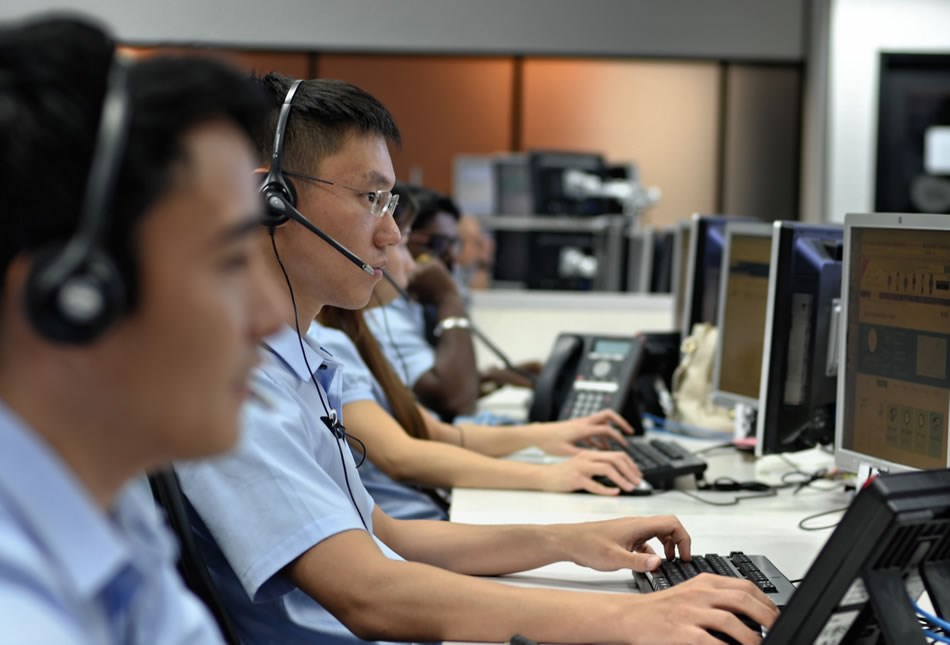 View of employees working at airport command center.